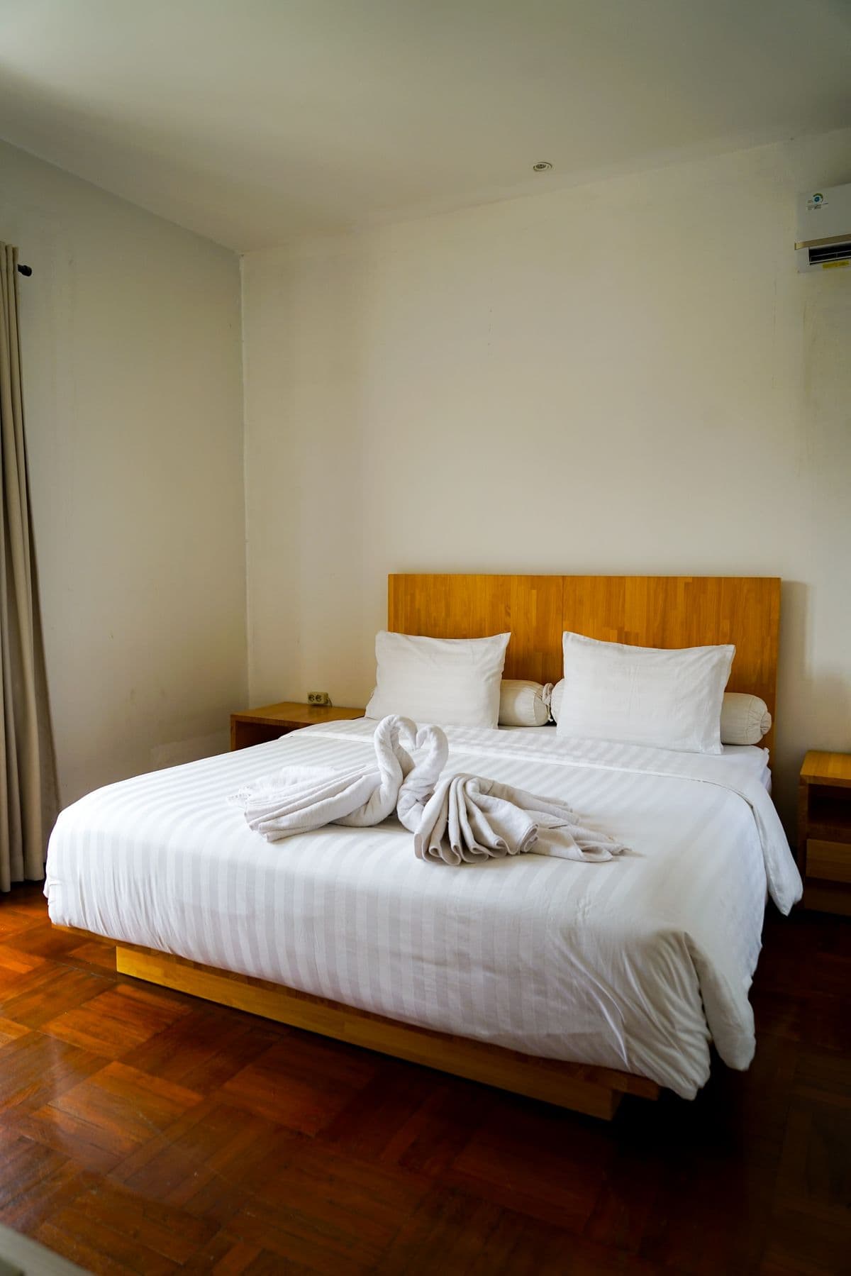A made bed and fresh towels ready for the next guest