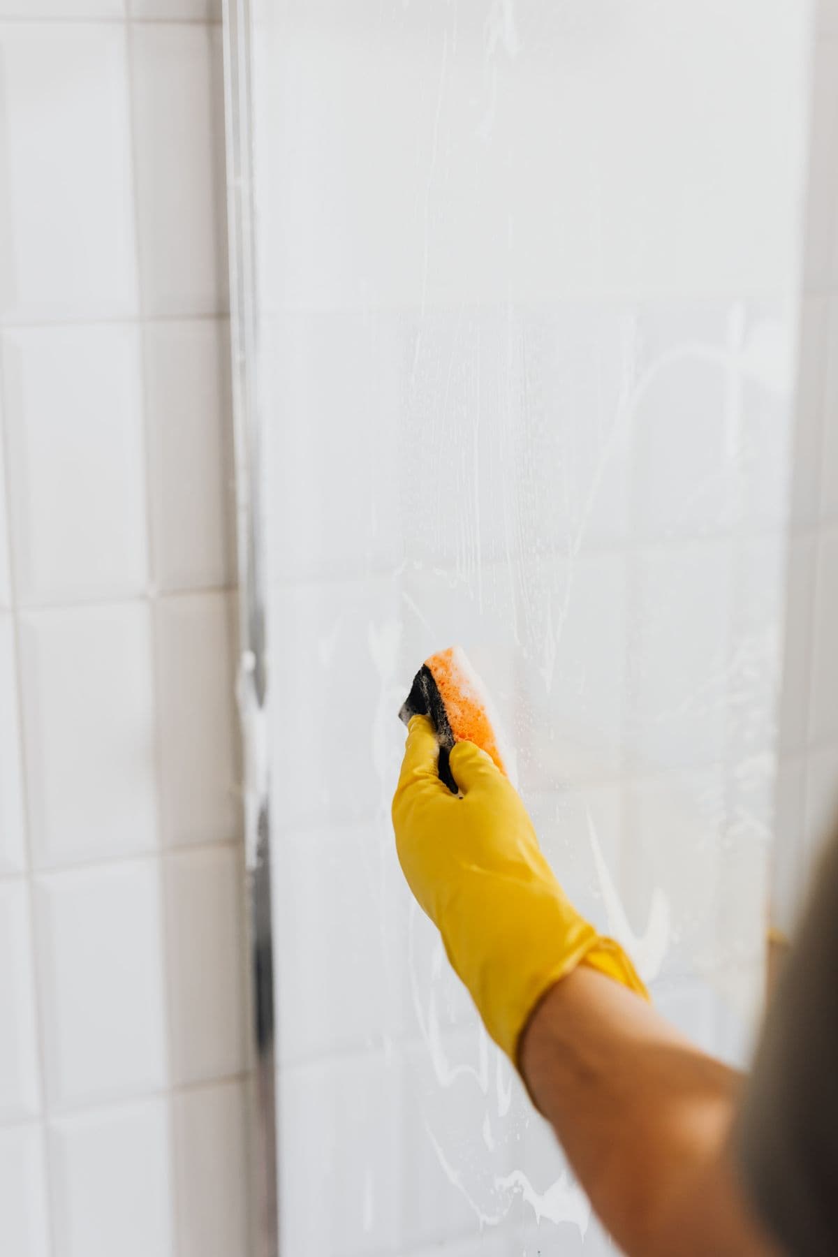 A cleaner wiping a baseboard during a deep cleaning